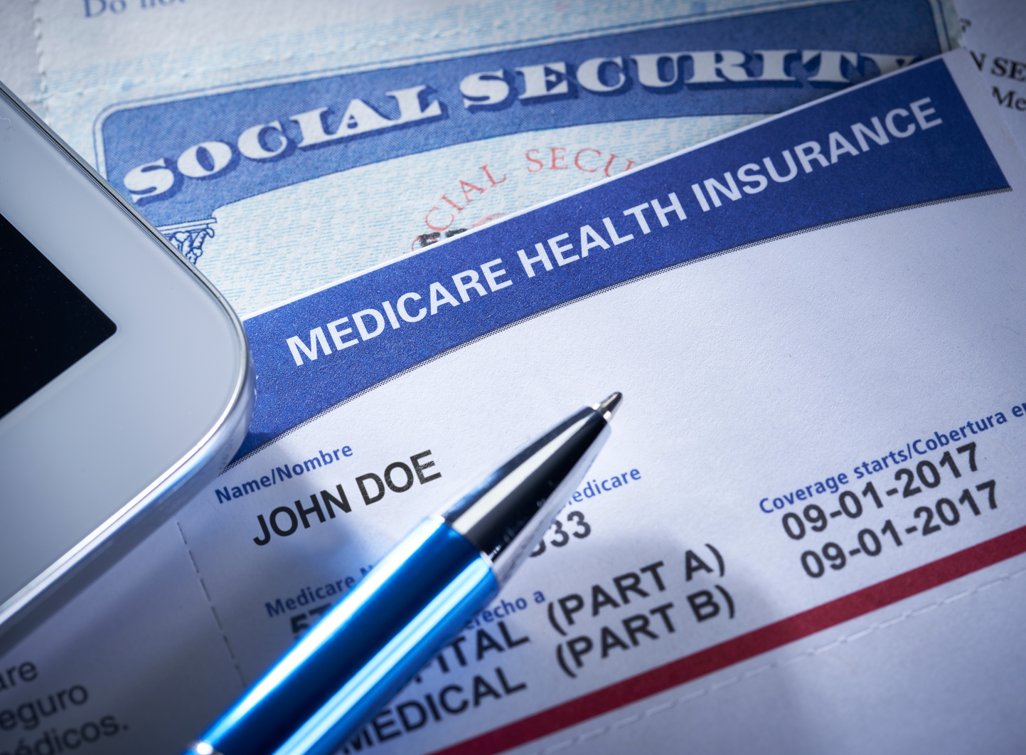 Medicare Health Insurance Card. Social Security Card with Stethoscope and smart phone.